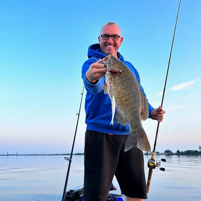 J.C. holding a smallmouth bass at first light