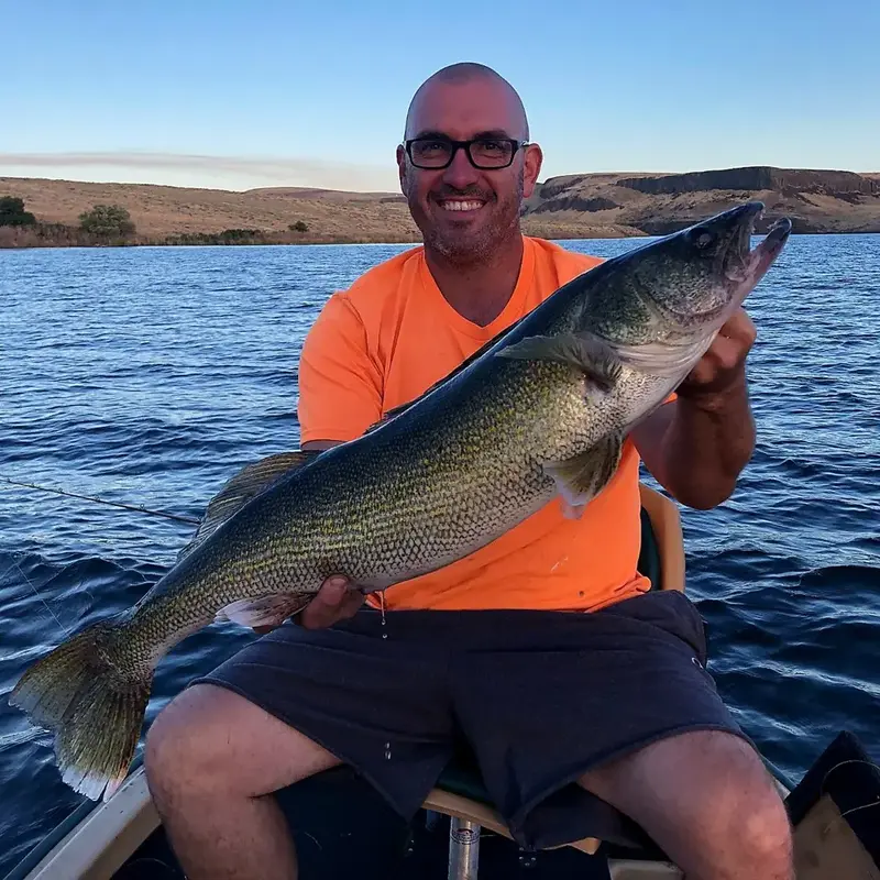 J.C. holding a walleye on the river