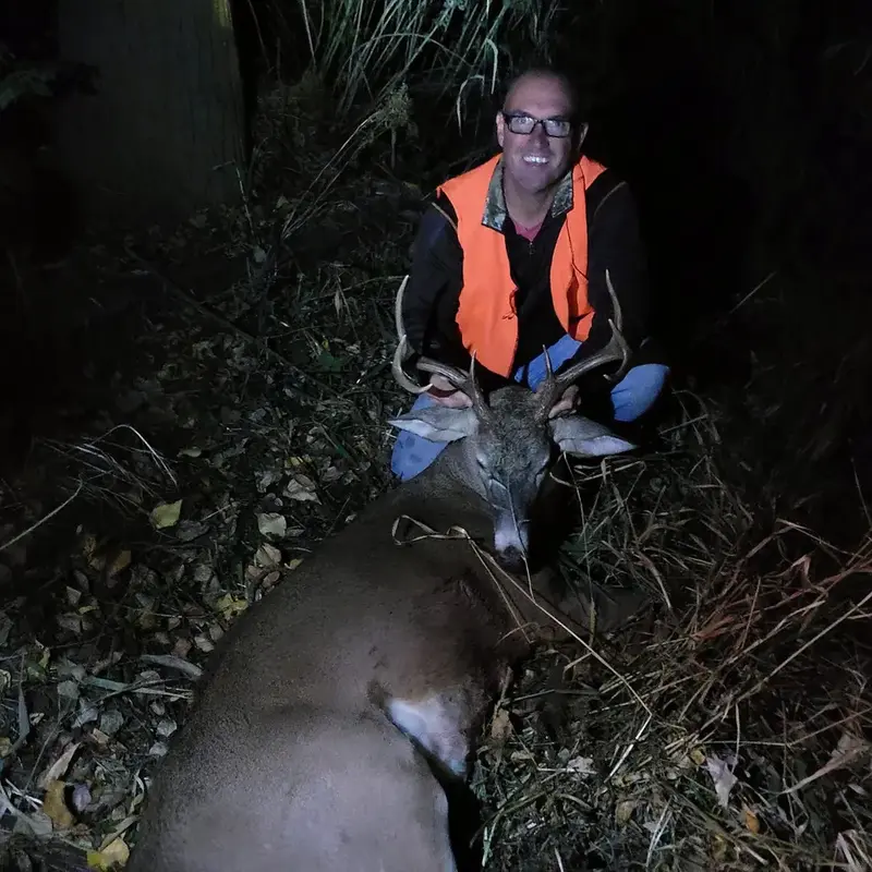 J.C. with a whitetail buck taken at last light