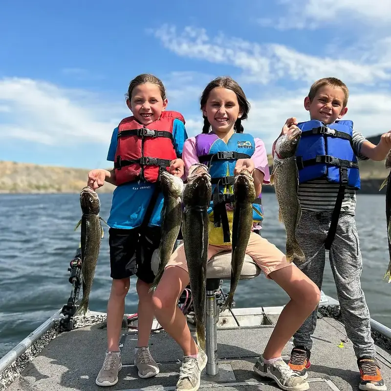Three of the kids holding a limit of walleye